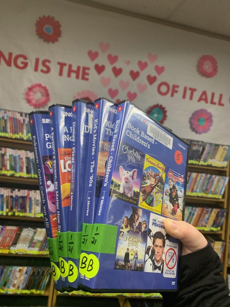 Image of 5 DVDs in library's "binge box" collection. Book based children's movies, 90's kids movies, Disney Pixar, A Person's a Person No Matter how Small, and Pokémon.